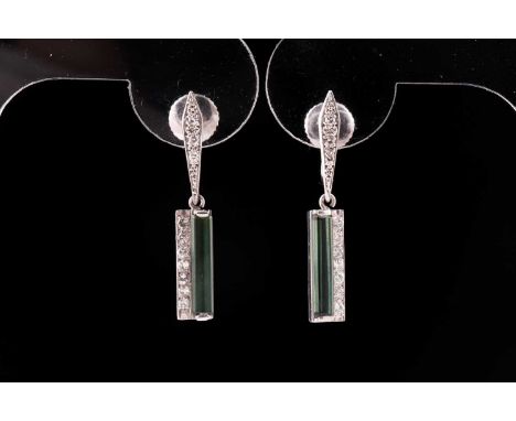 A pair of chrome tourmaline and diamond drop earrings; the elongated step cut tourmalines with seven round brilliant cut diam