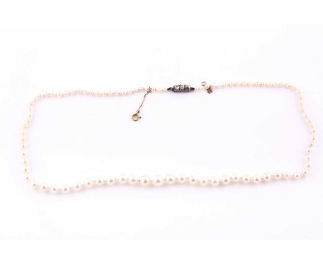 A graduated pearl necklace, the pearls measuring approximately 2.7 - 7.2 mm diameter, the clasp set with three old-cut diamon