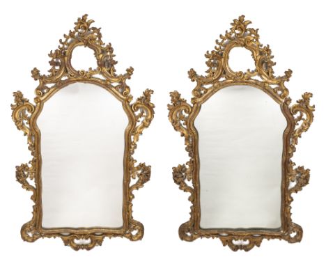 The gilt frames with pierced crests and scrolling arabesque ornament around shaped mirror plates.165cm x 100cmQty: 2In genera