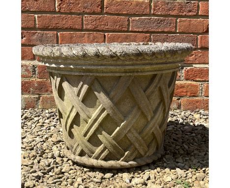 The cast reconstituted stone planter with rope twist border.53cm diameter x 38cm highIn weathered condition and with a hairli
