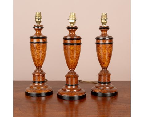 With ebonised banding and scumbled decoration to the bodies, raised on spreading stepped plinth bases.39cm high to the fittin