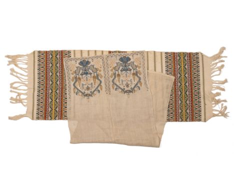 In two panels with decorative ends; together with a further Middle Eastern hand towel with needlework decoration.The first 11