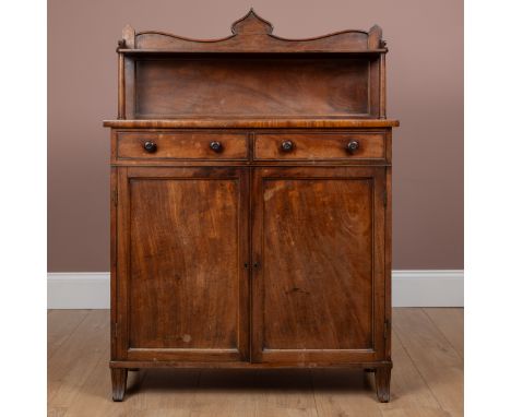 The super structure with a shaped gallery and turned supports, above two drawers with turned handles and a pair of panelled c