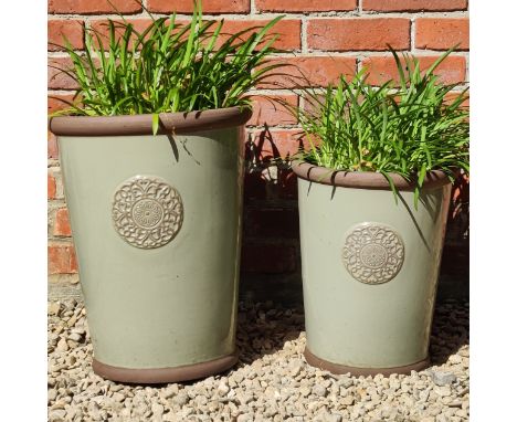 The two light green glazed pots planted out.The largest 37cm diameter x 46cm highQty: 2The modern pots in good condition.