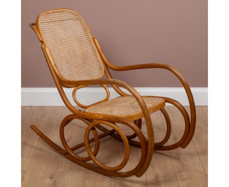 With a caned seat and back.51cm wide x 108cm deepGenerally good condition, with some light staining throughout.