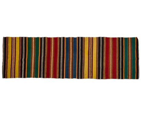 The first runner in green and red; the second in stripes of green, black, red, yellow and blue; and the final rug in pink, bl