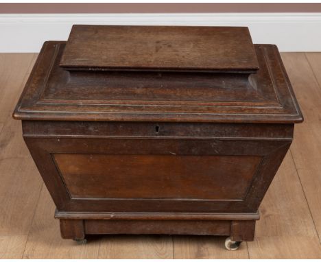 Of sarcophagus form, with segmented interior, the wine cooler mounted on later ceramic castors.64cm wide x 46cm deep x 53cm h