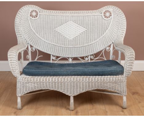 With shaped back and arms, blue button upholstered squab cushion and scroll ornament throughout.139cm wide x 110cm highMinor 