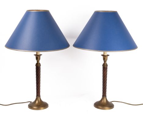With twisting fluted supports and spreading brass bases, with blue lampshades with gold trim.65cm high to the top of the shad