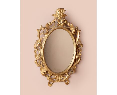 With a carved wooden frame, with acanthus leaf crest and surround, above a scallop decoration at the base.70cm x 46cmSome los