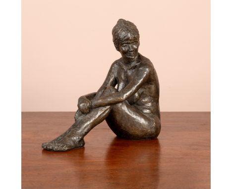 A bronze resin sculpture of a seated nude woman marked 'L.C'.26cm highGood, a little dusty.