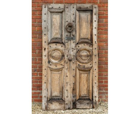With shaped panels, iron door knocker and later letter plate, with traces of original paintwork overall.108cm wide x 205cm hi