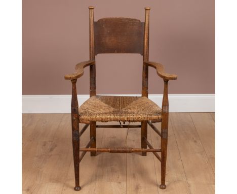 After a design by E G Punnett, likely made by William Birch, with a broad shaped splat in between finial topped ring turned s