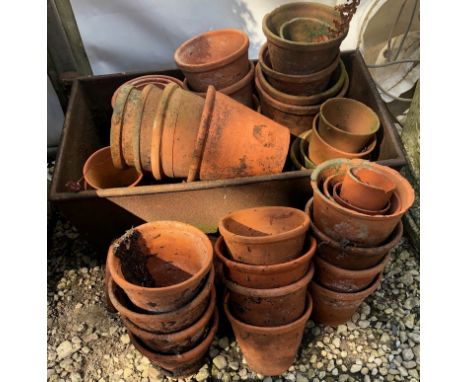 A rectangular cast iron garden trough and a collection of terracotta flower potsThe trough 57cm x 31cm 24cmAll in used and as