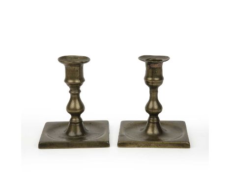 A pair of mid 18th century brass lantern candlesticks each with baluster stems and square bases, 12cm highRepair to flange of