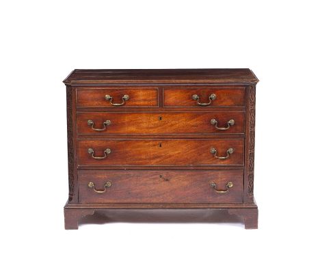 A George III mahogany chest of two short and three long drawers with brass swan neck handles, blind fretwork decoration and r