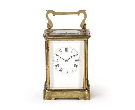A late 19th / early 20th century brass carriage clock the enamelled dial with roman numerals, having oval bevelled glass top 