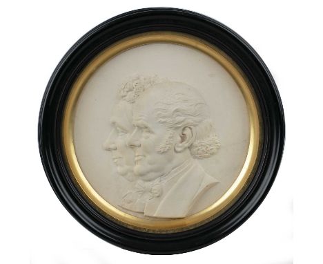 An early Victorian plaster portrait roundel of a lady and gentleman, with a gilded mount, ebonised frame and a Thomas Agnew &