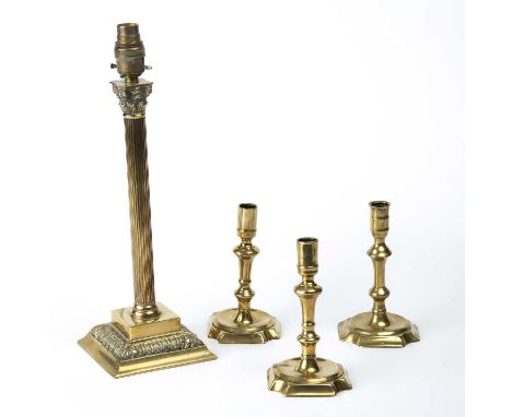 Three early 18th century English brass candlesticks the largest 17cm in height together with a gilt metal table lamp of corin