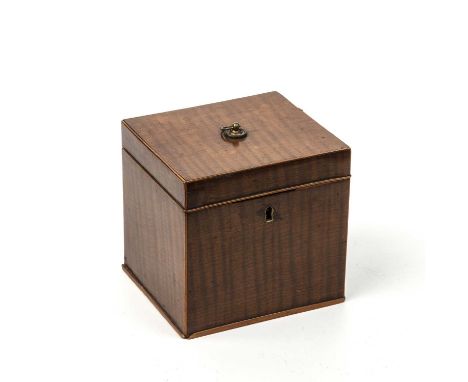 A George III possibly fustic tea caddy of cube form with fiddle back veneer, a ring handle and a later marbled paper interior