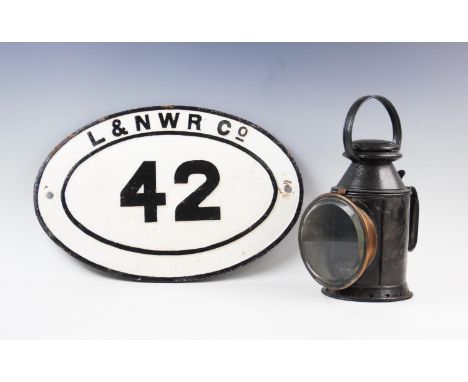 A vintage cast iron oval railway bridge sign, cast in relief with 'L &amp; N W R Co 42' with black letters on a white ground,