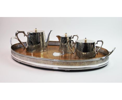 An oak gallery tray, of oval form with central shield medallion and pierced rim, 68cm wide, with a 20th century silver plated