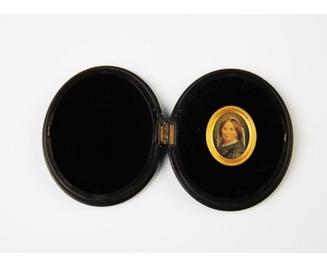 A portrait miniature of a Victorian lady, late 19th century, the miniature mounted in a gilt metal frame and set in a velvet 