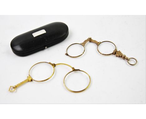 A pair of gilt metal lorgnette glasses, early 20th century, in associated case, with a further pair of sprung lorgnette glass