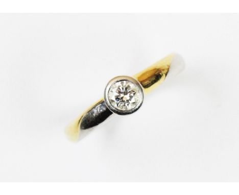 A diamond solitaire platinum ring, the round brilliant cut diamond collet set in platinum, bi-coloured shoulders, plain polis