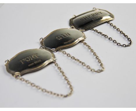 Three 20th century silver decanter labels, for Port, Sherry and Gin, all of angular lozenge type form, with attached chains, 