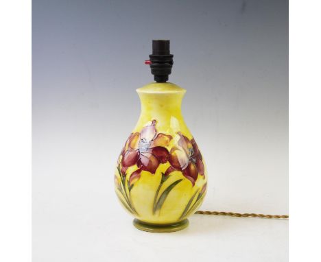 A Moorcroft table lamp of baluster form, decorated with lily's against a yellow ground, 30cm high (with fitting) Lighting lot