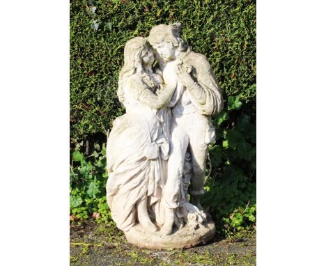 A reconstituted stone garden ornament, modelled as a courting couple upon a circular base, 73cm high 