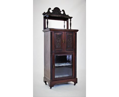 An Edwardian walnut music cabinet,with a swans neck pediment above a single shelf and rectangular mirror back, upon a rectang