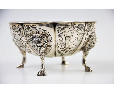 A continental white metal bowl, the floral form bowl, with eight defined panels, decorated with a selection of fauna, raised 