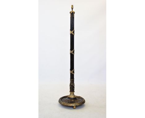 A bronzed metal cluster column standard lamp, 20th century, applied with gilt metal ribbon embellishments and raised upon a c