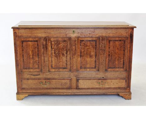 A George III oak and cross banded mule chest, with four mahogany cross banded panels above a pair of drawers applied with bra