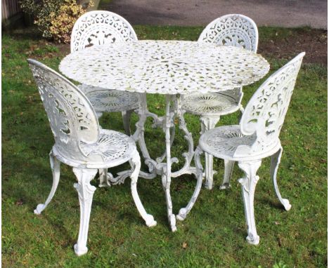 A painted metal patio/garden set, 20th century, comprising; a circular open work table on a cast leafy triform base along wit