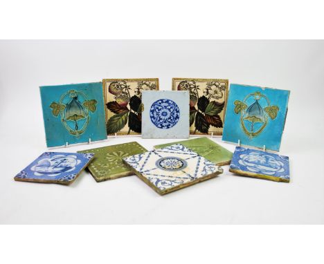 Two 19th century Dutch blue and white ceramic tiles, 13cm square, a third tile centred with a blue foliate roundel, along wit