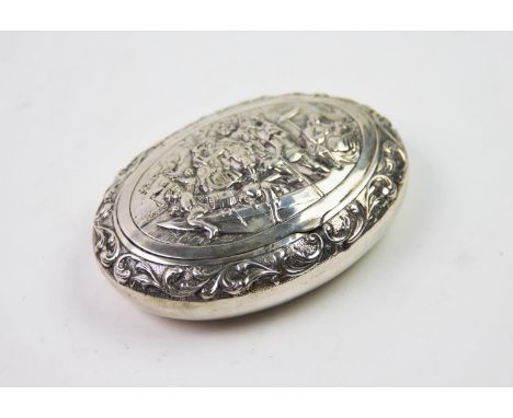 A 19th century Dutch silver snuff box, of oval form, the cover decorated with embossed figures on a barge, all within a folia