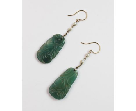 A pair of carved jade and freshwater pearl drop earrings, total length of drop 5cm, upon 9ct yellow gold shepard's hook fitti