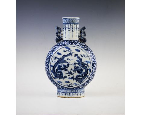 A Chinese porcelain blue and white moon flask, early 19th century, of typical form decorated to each circular face with two c