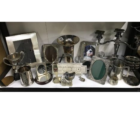 A shelf of sliver and sliver plated items