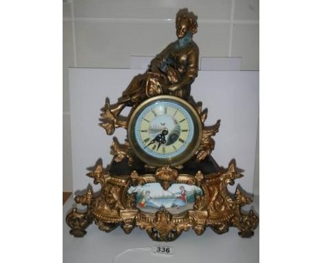 A good 20th century mantel clock surmounted figure and with handpainted dial and panel, with battery movement, in working ord