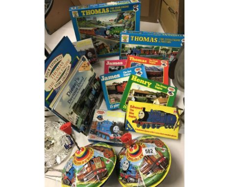 A collection of Thomas the Tank Engine items including spinning tops and puzzles