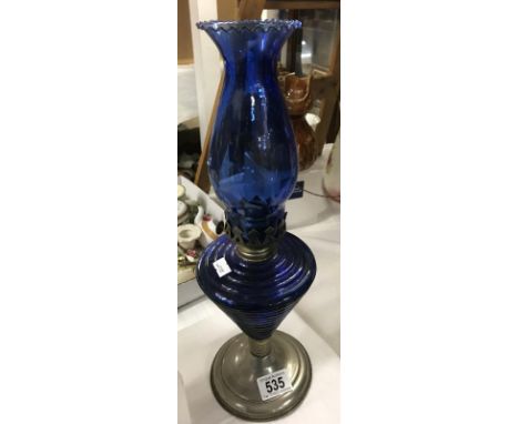 A Oil lamp with blue glass shade