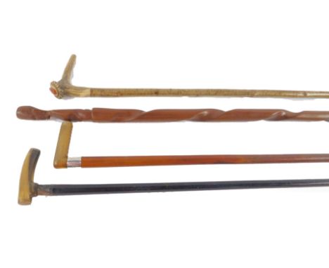 An African hardwood tribal walking stick, 91cm long, two walking sticks with horn handles, and a further walking stick with a