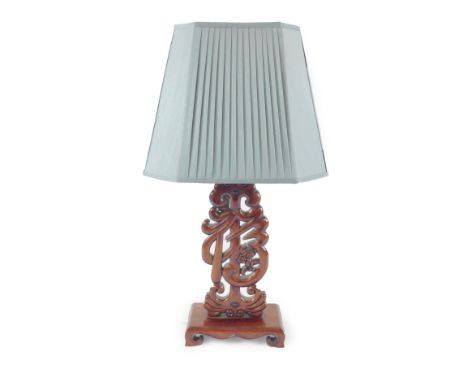 A Chinese hardwood table lamp, with a pleated faux silk green shade, 76cm high.