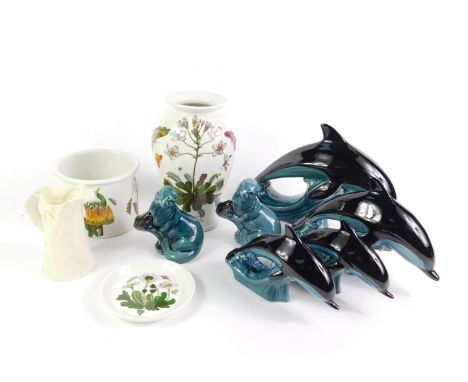 Four Poole Pottery dolphins, modelled in three sizes, two seals holding salmon, a Royal Worcester white leaf shaped jug, Port