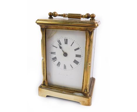 A brass carriage clock, enamel dial bearing Roman numerals, with key, 12cm H, 8cm W, 6.5cm D.