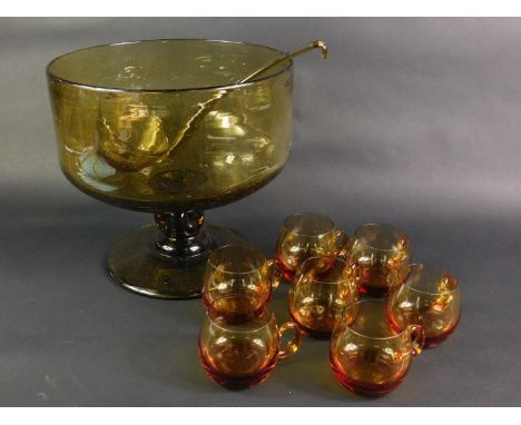 A late 20thC amber glass punch bowl, raised on a single knopped stem and conical foot, together with a ladle, bowl 28cm dia, 